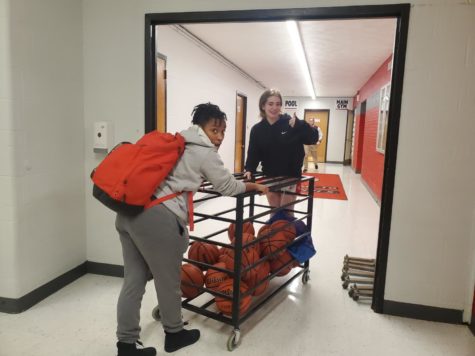Sophomore basketball players Jillian Douglas and Hannah Salkeld help set up in the main gym for a game on Jan 24. Coach Thompson said We are having a really good season and look to continue to improve!
