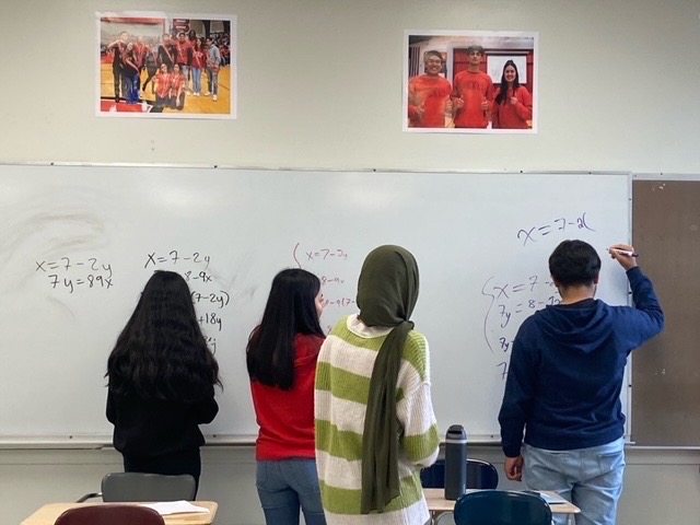 The Freshman Mathletes work out systems of equations at their weekly practice in room 137 as they get ready for their next competition, which will be held on Oct. 2. 
