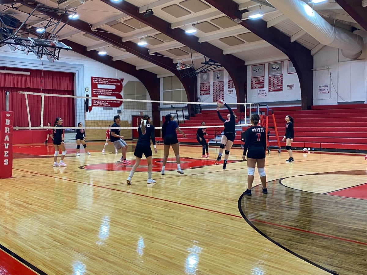 The girls volleyball team warms up in the Bremen gym before their game against Eisenhower on Sept. 10. Both the varsity and JV teams beat the Cardinals!