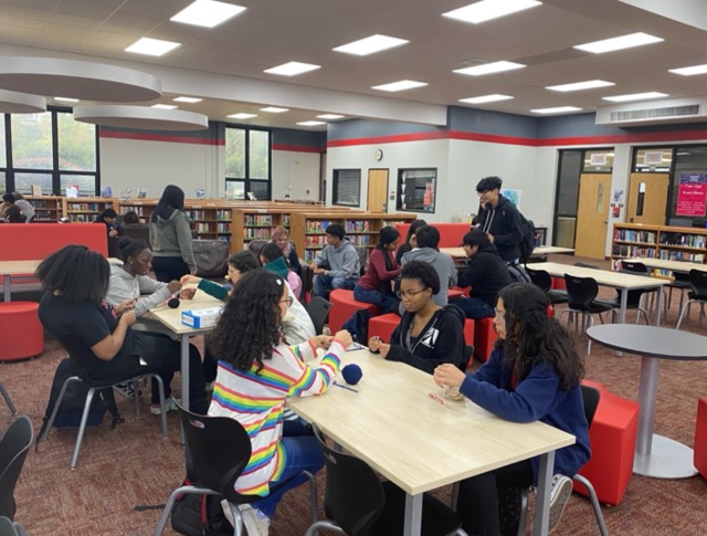 Members of the Interact Club crochets blankets on Oct. 22. The club plans to donate the completed blankets to the Sleep in Heavenly Peace organization for children who do not have blankets.