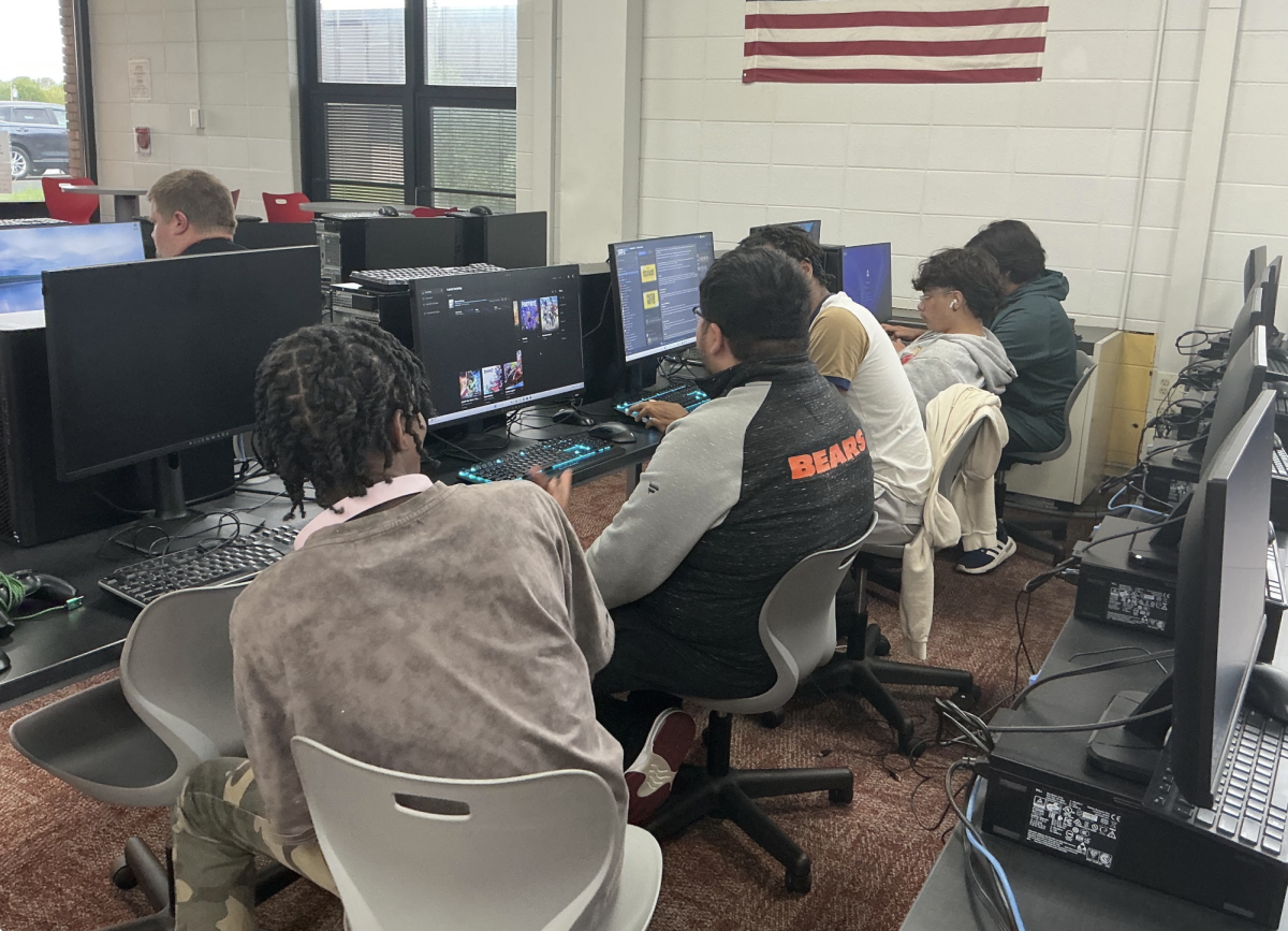 Members of the gaming/esports club work to download games to play as they begin preparing for the upcoming competitive season.