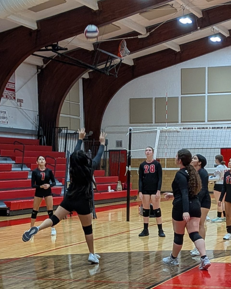 The Girls JV Volleyball team warms up before their Sept. 23 home game against T F South High School. 