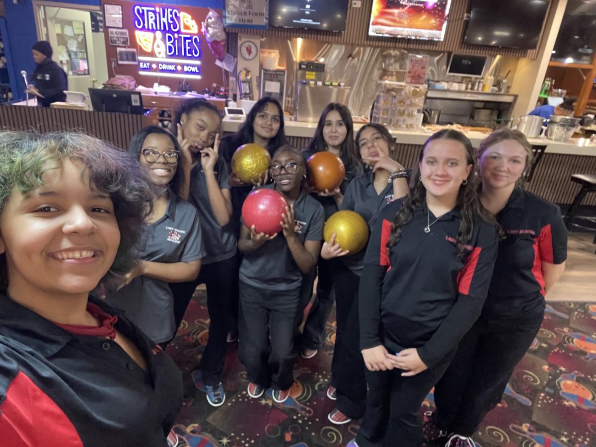 The Bremen girls bowling team poses at Strikes and Bites bowling alley in Lansing on Dec. 9. The varsity team defeated TF South 1130-1058!