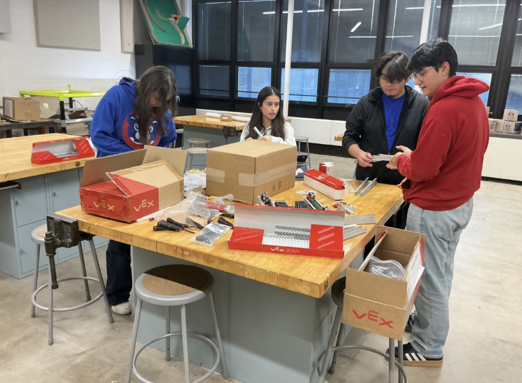 Members of the Robotics Club prepares their robots for the April competition at Governors State University.