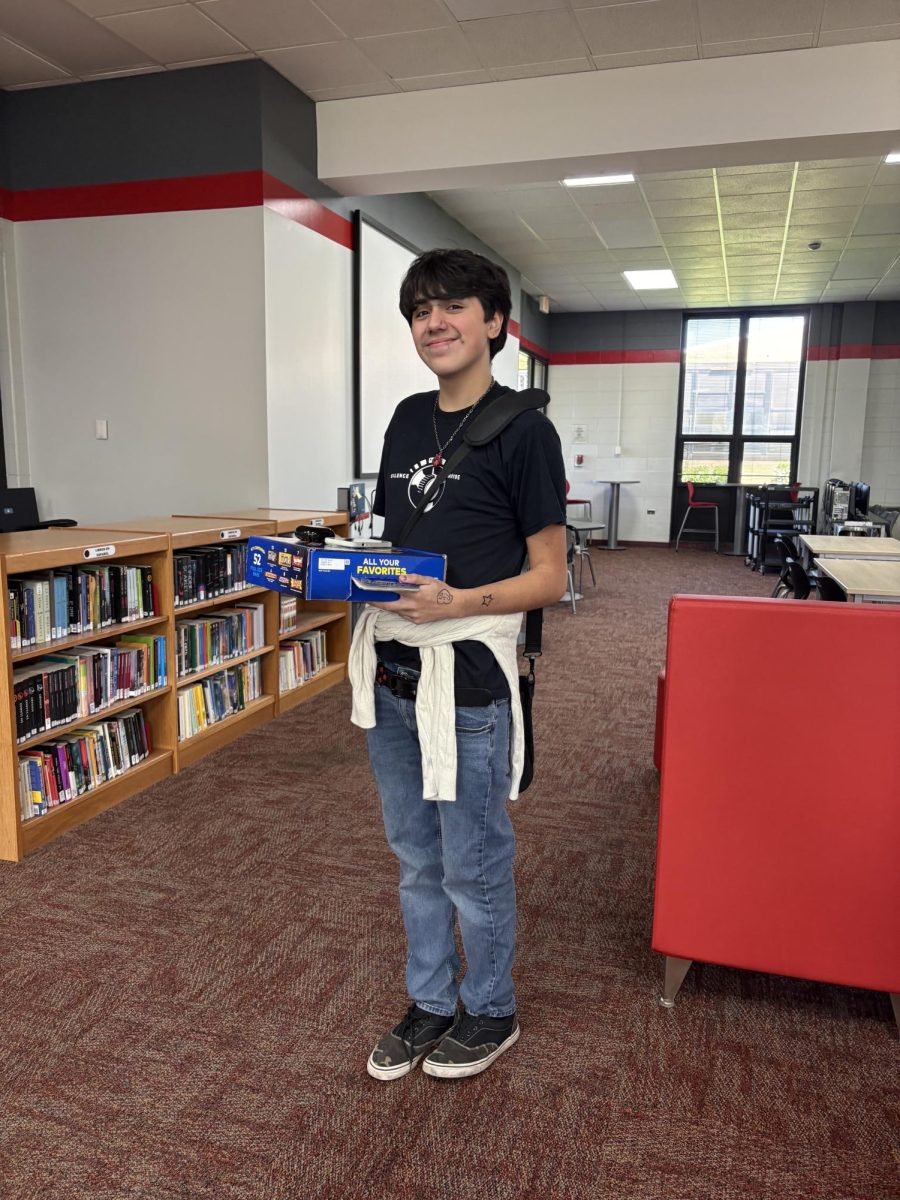 Chess Club member Ethan Avalos sells sweet confections on April 28th to raise money for new equipment for the Bremen Chess Team.